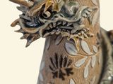 a vase with a dragon on it sitting on a table