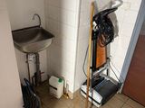 a bathroom with a sink and a broom in it