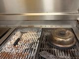 a stove top with a burner on it in a kitchen