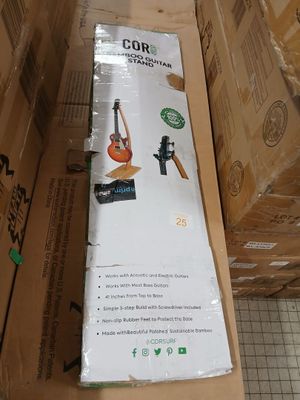 a cardboard box with a guitar in it sitting on the floor