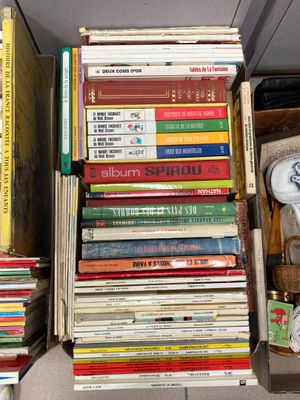 a lot of books that are stacked on top of each other