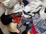 a basket full of clothes that is sitting on the floor