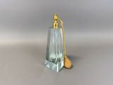an image of a small glass bottle with a wooden spoon on a table