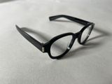 a pair of glasses sitting on a white surface