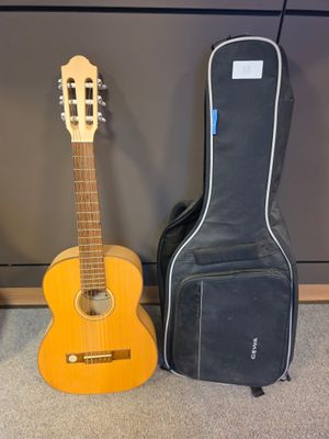 two guitars are sitting next to each other on the floor