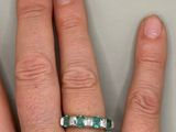 a person ' s hand with a ring on it ' s finger