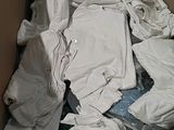 a cardboard box filled with clothes and other items