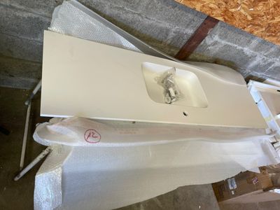 a white sink sitting on top of a white table