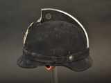 a black helmet on a metal stand against a black background