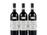 three bottles of wine sitting next to each other on a white surface