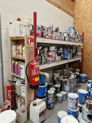 many cans of paint and cans of paint on the shelves