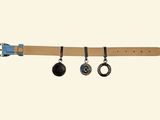 a picture of a belt with three charms hanging from it