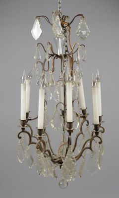 a close up of a chandelier with five candles on it