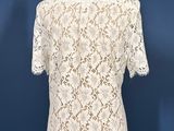a close up of a white lace top on a mannequin mannequin