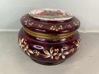 a red and gold box sitting on a white surface