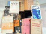 many books stacked on top of each other on a table