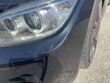a close up of a car ' s headlight on the street