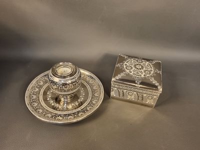 two silverplated candlesticks and a box on a table