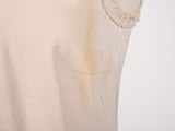 beige dress with lace detail on the shoulders and shoulders