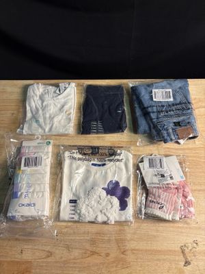 plusieurs paires de vêtements pour homme posées sur une table en bois