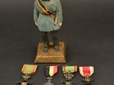 figurine of a soldier with medals and medals on a table