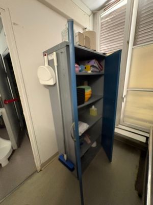 a blue cabinet in the corner of a room