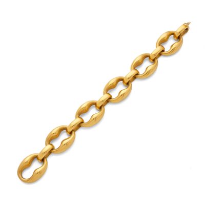 a yellow gold bracelet with oval links on a white background
