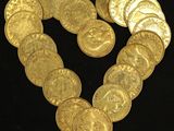 a heart made out of gold coins on a black background