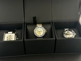 three watches in a black box on a table