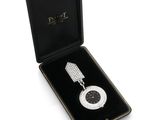 an image of a watch in a black case with a diamond on it