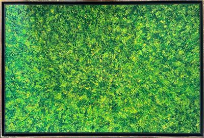 a painting of green grass in a wooden frame on a wall