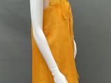 an image of a mannequin wearing a yellow dress with ruffles
