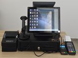 an image of a pos terminal on a desk with a keyboard and a phone