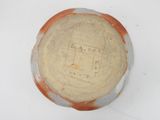 a brown and white bowl sitting on a white surface