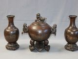 three vases sitting next to each other on a table