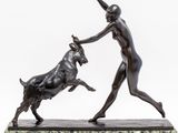 an image of a statue of a woman playing with a bull