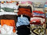 a lot of clothes that are sitting on a table