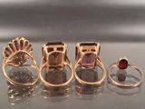 several different rings are arranged in a row on a table