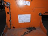 an orange machine with a chain attached to it ' s back