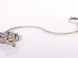 a close up of a necklace with a flower design on it