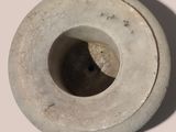 a white vase with a hole in the middle of it