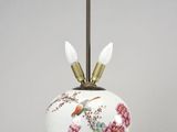 an image of a white vase with flowers and birds on it