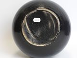 an image of a black vase with a hole in it