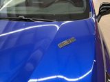 a picture of a blue car parked in a garage