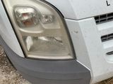a close up of a white van parked in a lot