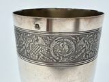 a silver cup that is sitting on a table