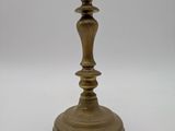 an antique brass candle holder on a white background