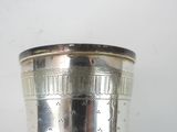 a silver cup that is sitting on a table