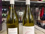 two bottles of wine sitting on a table in a store