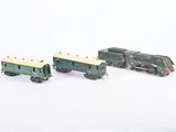 three toy trains that are sitting on a white surface